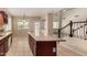 Bright kitchen with large island, tile floors, stainless steel appliances and views of the stairs at 8214 S 48Th Dr, Laveen, AZ 85339