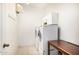Bright laundry room with white cabinets, tile floor, washer and dryer at 8214 S 48Th Dr, Laveen, AZ 85339