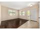 Inviting living room with hard wood flooring and natural light streaming through large windows at 8214 S 48Th Dr, Laveen, AZ 85339