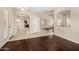 Open-concept living room with hard wood flooring. A doorway leads into an eat-in kitchen at 8214 S 48Th Dr, Laveen, AZ 85339