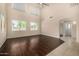 Bright living room features high ceilings, large windows, and elegant hardwood flooring at 8214 S 48Th Dr, Laveen, AZ 85339
