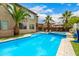 Backyard pool and spa feature palm trees, lounge chairs, and a covered outdoor seating area at 8214 S 48Th Dr, Laveen, AZ 85339