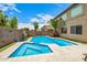 A backyard pool features a built-in spa with surrounding artificial turf at 8214 S 48Th Dr, Laveen, AZ 85339