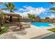 Backyard pool area with lounge chairs, a gazebo, and privacy walls and landscaping at 8214 S 48Th Dr, Laveen, AZ 85339