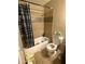 Cozy bathroom featuring tiled walls, bathtub with shower, and toilet at 9054 E Crescent Ave, Mesa, AZ 85208