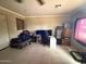 A bedroom with tile floors featuring a gaming setup, a bed, and storage furniture at 9054 E Crescent Ave, Mesa, AZ 85208