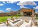 Inviting backyard featuring a cozy fire pit area with comfortable seating, perfect for outdoor entertaining at 9418 W Minnezona Ave, Phoenix, AZ 85037