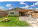 Beautiful backyard featuring a covered patio, outdoor kitchen, and a lush green lawn perfect for outdoor living at 9418 W Minnezona Ave, Phoenix, AZ 85037