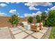 Relaxing backyard with a stylish fire pit area, comfortable seating, and desert-friendly landscaping at 9418 W Minnezona Ave, Phoenix, AZ 85037