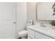 Contemporary bathroom with a sleek white vanity, modern fixtures, and neutral tiling at 9418 W Minnezona Ave, Phoenix, AZ 85037