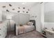 Cozy ' bedroom with butterfly decor, carpet, and a comfortable single bed at 9418 W Minnezona Ave, Phoenix, AZ 85037