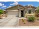 Charming single-story home featuring a two-car garage and desert landscaping at 9418 W Minnezona Ave, Phoenix, AZ 85037