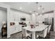 Modern kitchen with white cabinets, stainless steel appliances, and a large island at 9418 W Minnezona Ave, Phoenix, AZ 85037