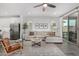 Bright living room with a sectional sofa, stylish rug, and sliding glass doors at 9418 W Minnezona Ave, Phoenix, AZ 85037