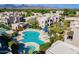Aerial view of a community pool, lounge chairs, landscaping and surrounding community and mountain range at 11260 N 92Nd St # 2111, Scottsdale, AZ 85260