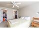 Light-filled bedroom with neutral walls, ceiling fan, and access to en suite and closet at 11260 N 92Nd St # 2111, Scottsdale, AZ 85260