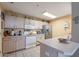 Well-lit kitchen with ample counter space, white appliances, and tile flooring at 11260 N 92Nd St # 2111, Scottsdale, AZ 85260