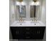 Bathroom with double vanity, modern fixtures, and black cabinetry at 1149 S 98Th St, Mesa, AZ 85208