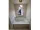 Bathroom featuring a bathtub and tiled walls at 1149 S 98Th St, Mesa, AZ 85208
