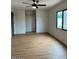 Bedroom with new flooring, ceiling fan, closet and view to the backyard at 1149 S 98Th St, Mesa, AZ 85208
