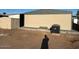 Tan exterior of mobile home next to shed and AC unit, shadow of person in yard at 1149 S 98Th St, Mesa, AZ 85208
