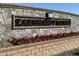 Stone and brick community welcome sign with flower beds at 1171 E Peach Tree Dr, Chandler, AZ 85249