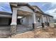New construction home showing covered front porch with stone column accents and metal railing at 1171 E Peach Tree Dr, Chandler, AZ 85249