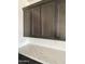 Kitchen featuring dark wood cabinets, white quartz countertops, and stainless steel hardware at 1171 E Peach Tree Dr, Chandler, AZ 85249