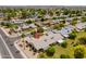 Aerial view of community featuring many homes with solar panels at 13055 W Tangelo Dr, Sun City West, AZ 85375