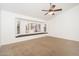 Cozy bedroom features carpeted floors, large windows with shutters, and a built-in seating area at 13055 W Tangelo Dr, Sun City West, AZ 85375