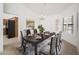 Dining room showcasing a large table with seating for six, a decorative chandelier, and plantation shutters at 13055 W Tangelo Dr, Sun City West, AZ 85375