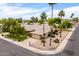 Charming home with desert landscaping, palm trees, and attached garage at 13055 W Tangelo Dr, Sun City West, AZ 85375