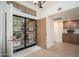 Inviting foyer featuring tile flooring, custom iron security door, and built-in cabinets in a well lit entry at 13055 W Tangelo Dr, Sun City West, AZ 85375