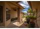 Inviting front entry featuring decorative landscaping and a covered porch at 13055 W Tangelo Dr, Sun City West, AZ 85375