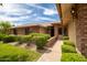 Charming front exterior with lush landscaping, brick accents, and inviting walkway at 13055 W Tangelo Dr, Sun City West, AZ 85375