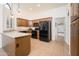 Spacious kitchen featuring modern appliances, light countertops, wooden cabinetry, and tile floors at 13055 W Tangelo Dr, Sun City West, AZ 85375