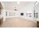 Bright, open living area with tile floors, ceiling fan and lots of natural light from large windows at 13055 W Tangelo Dr, Sun City West, AZ 85375