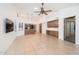 Bright living room with tile floors, natural light, ceiling fan and an open concept to the kitchen at 13055 W Tangelo Dr, Sun City West, AZ 85375
