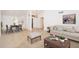 Bright living room showcasing an open floor plan, tile flooring, and a view of the front entry and dining area at 13055 W Tangelo Dr, Sun City West, AZ 85375
