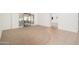 Bright living room with carpet and tile flooring, leading to an outdoor patio with shutter doors at 13055 W Tangelo Dr, Sun City West, AZ 85375