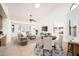 Open-concept living space with tile floors, a ceiling fan, and a view of the kitchen and dining area at 13055 W Tangelo Dr, Sun City West, AZ 85375