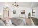 Bright main bedroom offers a relaxing retreat with a TV, bench seat, and plenty of natural light at 13055 W Tangelo Dr, Sun City West, AZ 85375