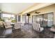 Relaxing covered patio with tile flooring, ceiling fan, and comfortable seating area at 13055 W Tangelo Dr, Sun City West, AZ 85375