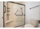 Modern shower area with glass doors, shelving, and accessible grab bars, ensuring both style and safety at 13055 W Tangelo Dr, Sun City West, AZ 85375