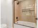 Bathroom with tub/shower combo with decorative tile surround at 13367 W Jesse Red Dr, Peoria, AZ 85383