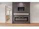 Modern fireplace with wood mantle and electric insert at 13367 W Jesse Red Dr, Peoria, AZ 85383