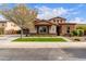 Beautiful two-story home featuring a stone facade, manicured lawn, and tasteful landscaping at 13367 W Jesse Red Dr, Peoria, AZ 85383