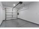 Clean garage with finished floor and white walls, offering a functional space at 13367 W Jesse Red Dr, Peoria, AZ 85383