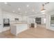 Bright and modern kitchen featuring stainless steel appliances, white cabinets, and a quartz island at 13367 W Jesse Red Dr, Peoria, AZ 85383
