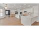 Bright, modern kitchen with white cabinets, quartz countertops, stainless steel appliances, and wood floors at 13367 W Jesse Red Dr, Peoria, AZ 85383